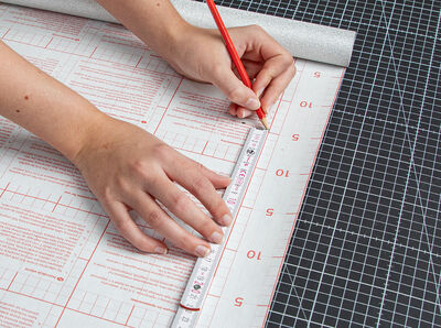 The measurements are transferred to the rear side of the Glitter silver using a ruler and pencil.