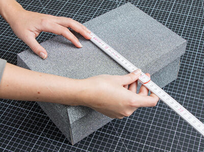 Measure the shoe box using a measuring tape. 